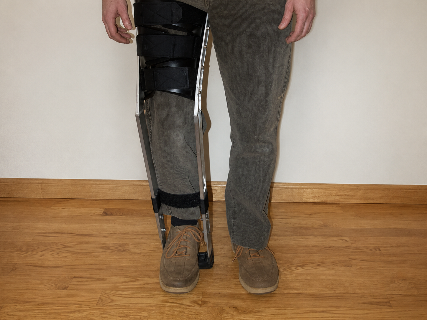 A woman climbing a staircase wearing the SoraStride brace, one hand on the railing